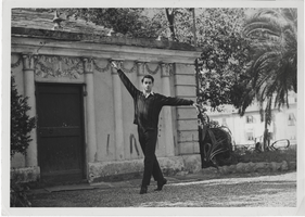 Photograph of Vassili Sulich posing in front of an unknown building, 1950s
