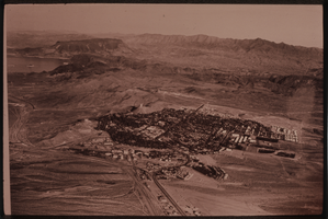 Black and white aerial view of Boulder City. Lake Mead is visible in the background.