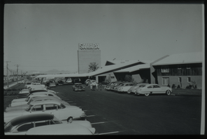 Black and white view of the Sahara Hotel and parking lot.