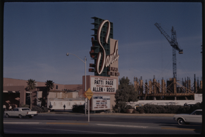 Color view of the Sands Hotel marquee featuring Patti Page and Alle & Rossi. An addition to the Sands is under construction behind the marquee.