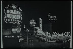 Black and white view of Downtown Las Vegas. The Golden Nugget, Eldorado Club, Hotel Apache, Boulder Club, and Pioneer Club are visible.