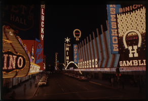 Color view of Downtown Las Vegas at night. The Golden Nugget, Lucky, Binion's Horsehoe, The Mint, and the Las Vegas Club are visible.
