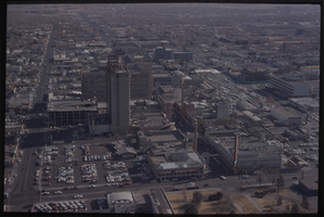 Color aerial view of the Fremont Hotel under construction. Lucky, The Mint, and Las Vegas Club are also visible.