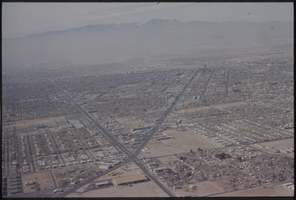 Color aerial view of Las Vegas. Mount Charleston is visible in the background.