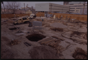 Color view of a construction site. The Clark County Courthouse is visible in the background. A sign in the background offers weddings for $10.00.