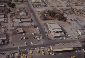 Color aerial view of Las Vegas. The Culinary Workers Union Local 226 building is visible across the street from a yellow cab company parking lot.