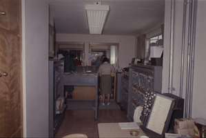 Color view of two women working in a filing area.