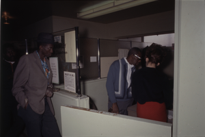 Color view of three people in an office meeting.