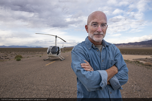 Jamey Stillings with a Robinson R44 helicopter on a road, near Tonopah, Nevada: digital photograph