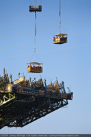 Photograph of ironworkers being transported in manbaskets during Mike O'Callaghan-Pat Tillman Memorial Bridge construction near the Arizona side of Hoover Dam, April 29, 2009