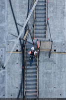 Photograph of construction worker climbing up a staircase during arch construction for the Mike O'Callaghan-Pat Tillman Memorial Bridge, Nevada border, May 20, 2009