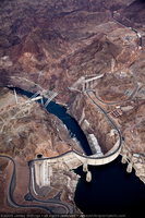 Photograph showing an aerial view of Hoover Dam, the original road between Arizona and Nevada, and the Mike O'Callaghan-Pat Tillman Memorial Bridge under construction, Nevada-Arizona border, May 22, 2009