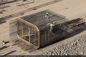 Photograph of ironworkers fabricating rebar forms to be used for construction of the Mike O'Callaghan-Pat Tillman Memorial Bridge, Arizona, June 29, 2009