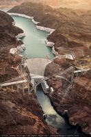 Photograph showing an aerial view of Lake Mead, Hoover Dam, and the Mike O'Callaghan-Pat Tillman Memorial Bridge under construction, Nevada-Arizona border, June 30, 2009