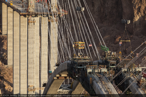 Photograph of workers arriving to work at the Mike O'Callaghan-Pat Tillman Memorial Bridge via highline crane and manbaskets, Nevada-Arizona border, July 1, 2009