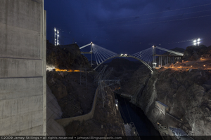 Photograph of the Mike O'Callaghan-Pat Tillman Memorial Bridge being constructed over the Colorado River just before dawn, before dawn, July 2, 2009