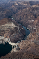 Photograph showing an aerial view of the completed arch of the Mike O'Callaghan-Pat Tillman Memorial Bridge, Hoover Dam, Lake Mead, and the Colorado River, September 10, 2009