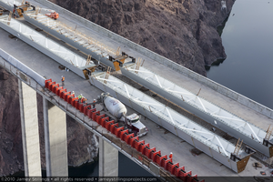 Photograph of workers pouring concrete for the walkway barriers during construction of the Mike O'Callaghan-Pat Tillman Memorial Bridge, Nevada border, February 2, 2010