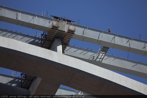 Photograph of an ironworker near the arch and girder of the Mike O'Callaghan-Pat Tillman Memorial Bridge during the construction phase, Nevada-Arizona border, February 3, 2010