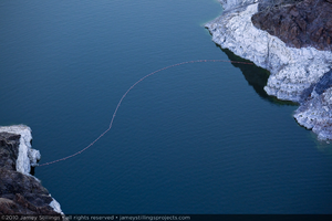 Photograph of a line of floats crossing Lake Mead to set a boundary for boats nearing Hoover Dam, February 3, 2010