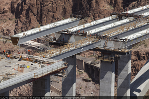 Photograph of the second of the final four tub girders for the Mike O' Callaghan-Pat Tillman Memorial Bridge being flown into position via highline crane, Nevada-Arizona border, April 15, 2010