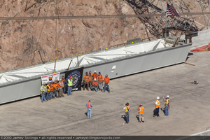 Photograph of ironworkers and management posing for photos during construction at the Mike O'Callaghan-Pat Tillman Memorial Bridge, Nevada-Arizona border, April 15, 2010