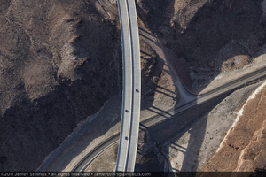 Photograph showing an aerial view of cars driving on the road constructed for the Hoover Dam Bypass Project, Arizona side of Hoover Dam, January 14, 2011
