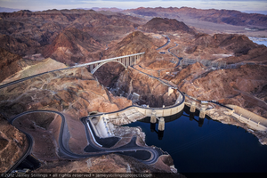 Photograph showing an aerial view of the Mike O'Callaghan-Pat Tillman Memorial Bridge and Hoover Dam, Nevada-Arizona border, April 10, 2012