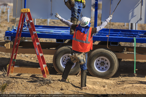 Photograph of worker guiding crane operator, June 4, 2012