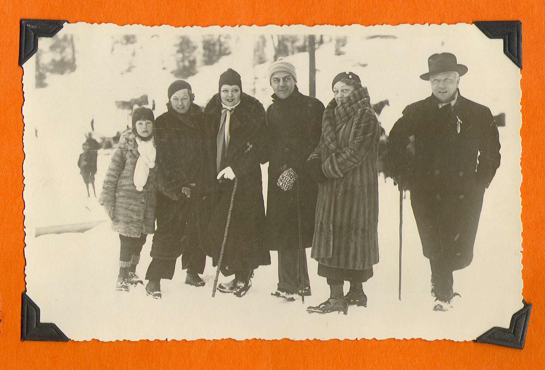 Clara Bow Bell and a group of unidentified people at bottom of ski slopes in Europe: photographic print