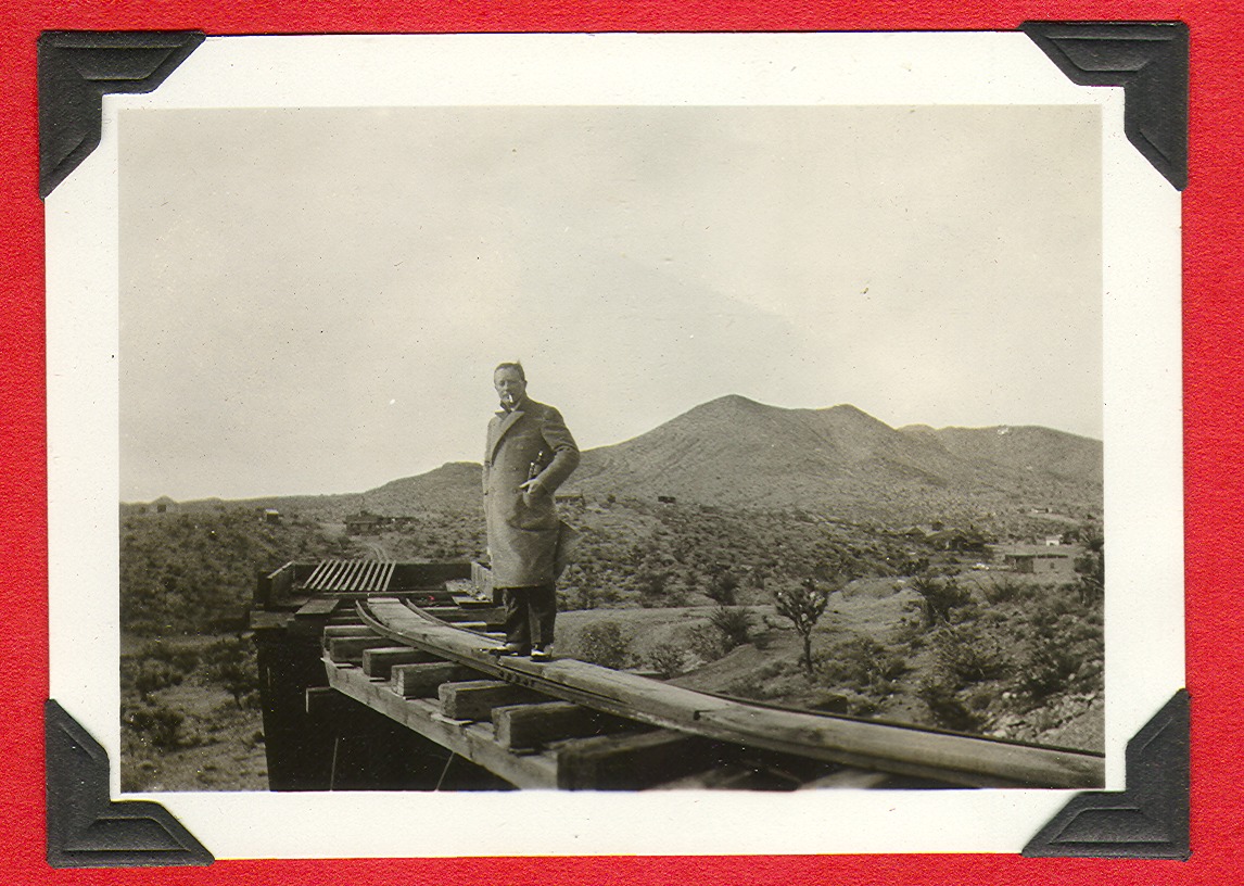 Unidentified man standing on railroad tracks: photographic print