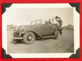 Clara Bow Bell in the driver's seat along with other people in a car: photographic print