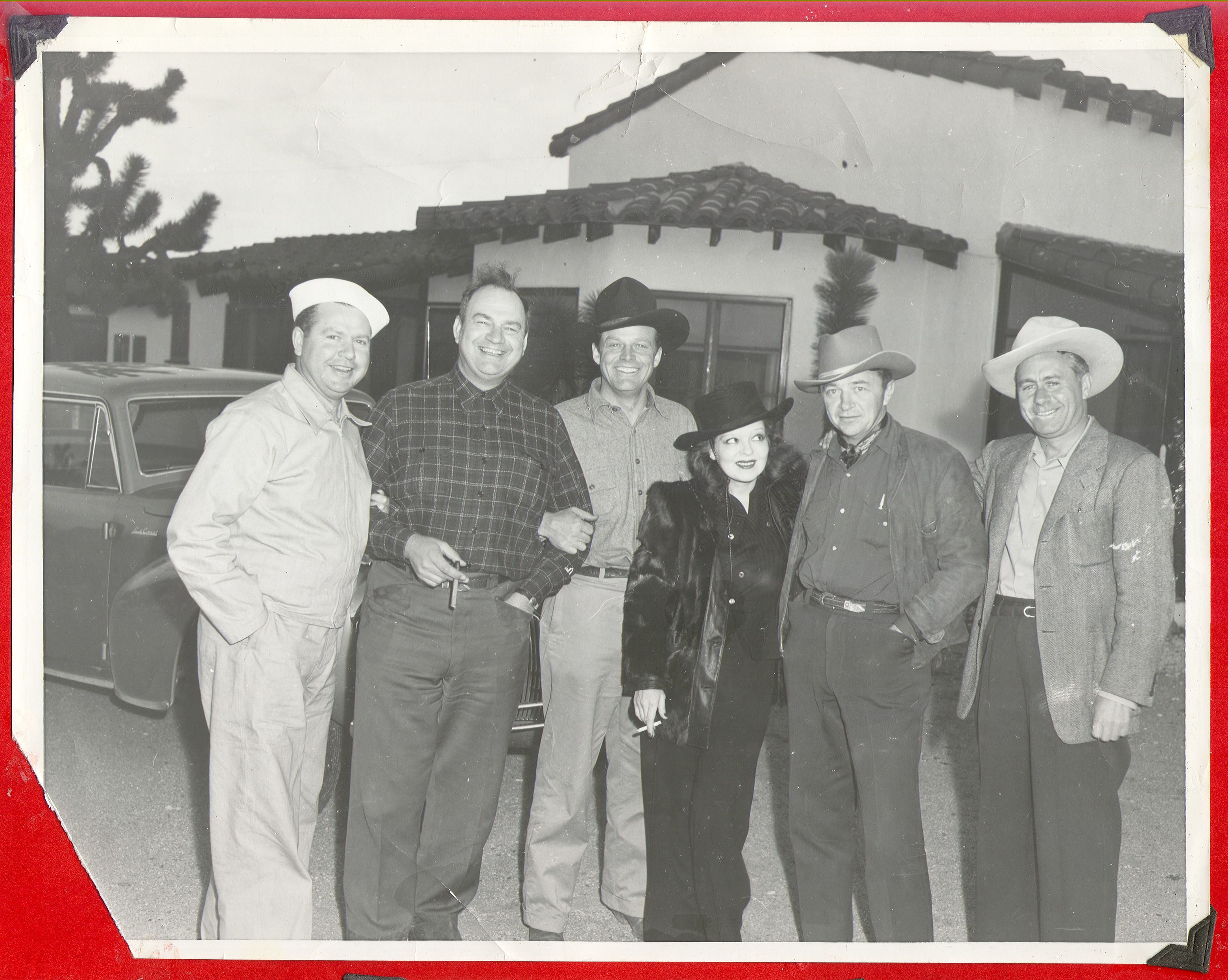 Rex Bell and Clara Bow Bell, center, with four unidentified men: photographic print