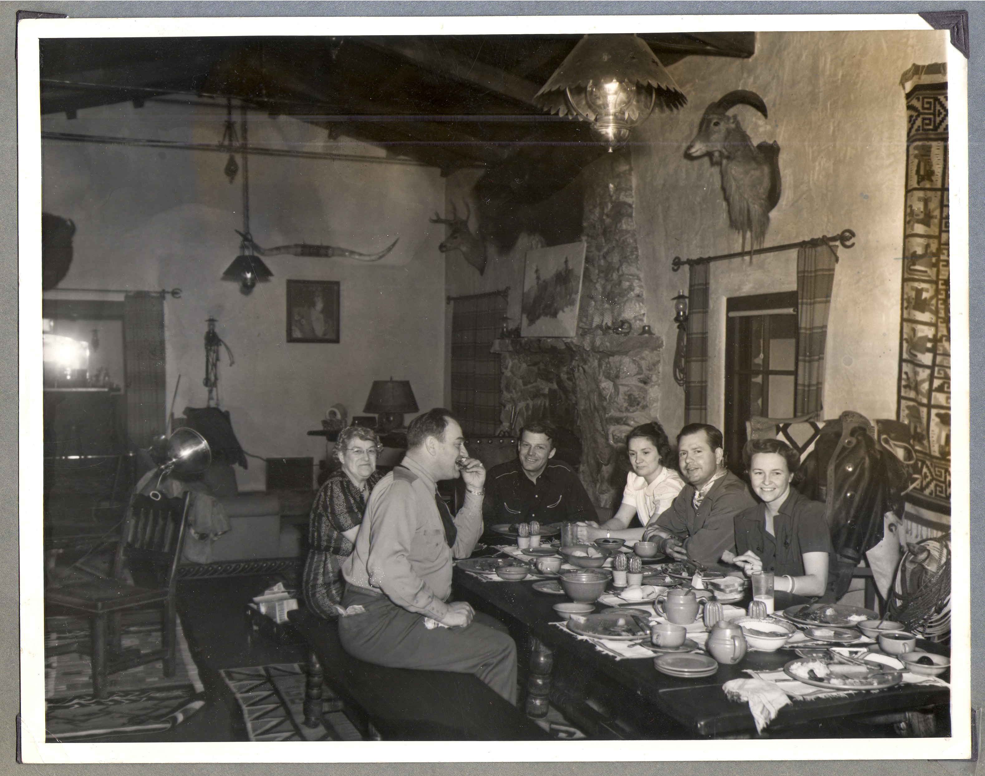 Group of people seated at the dining room table: photographic print
