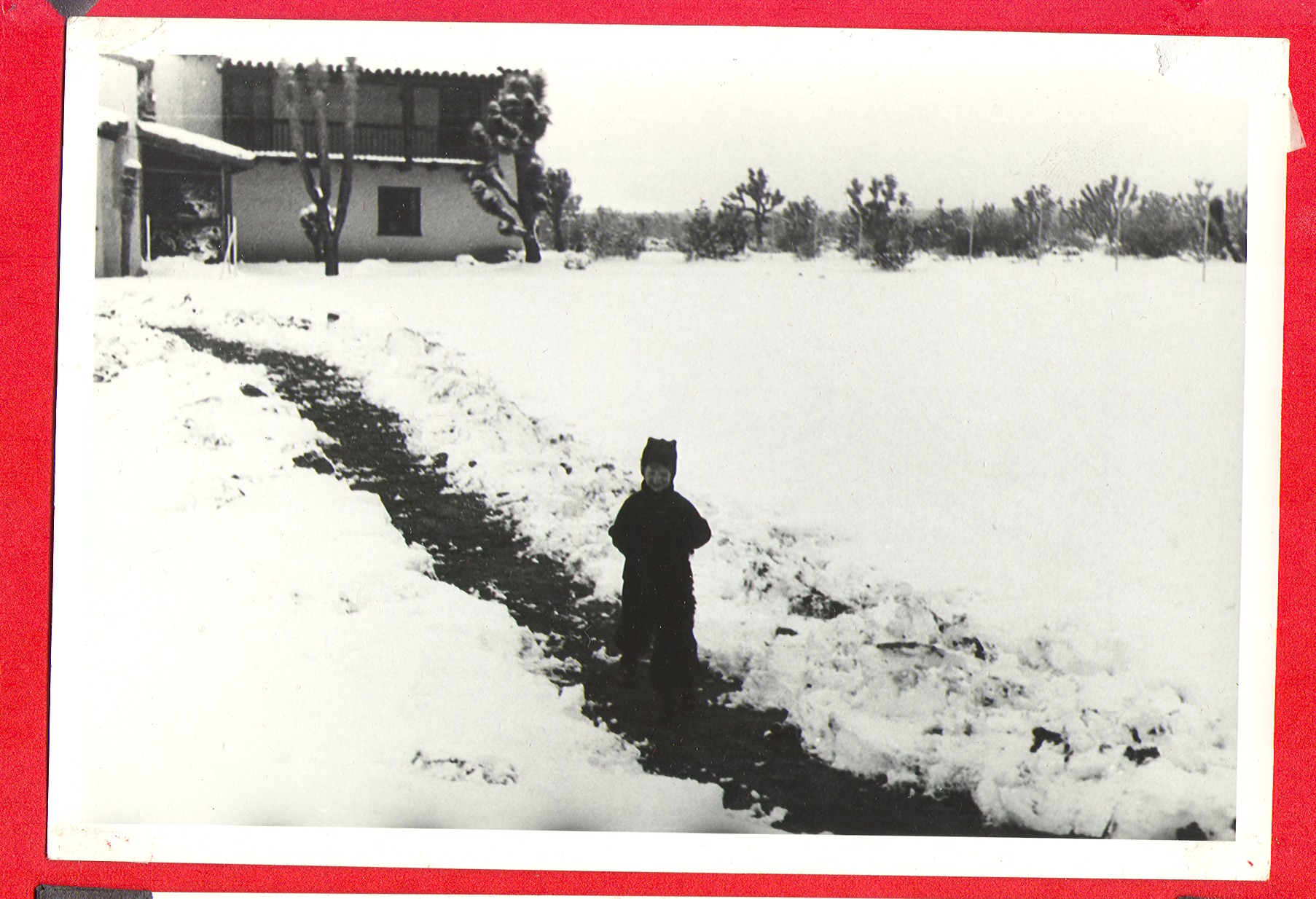 Rex Bell Jr. outside the ranch house in the snow: photographic print
