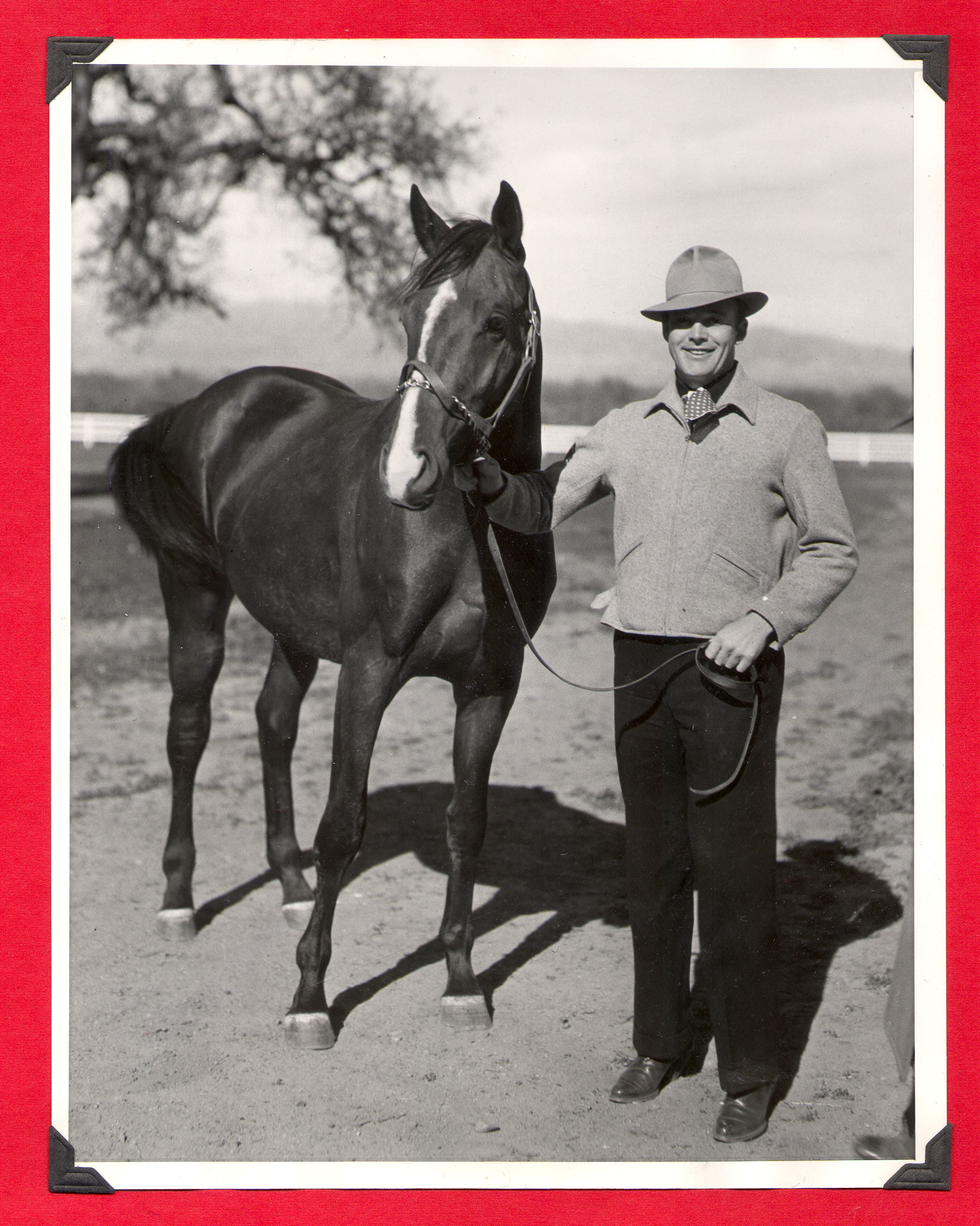 Unidentified man with Rex Bell's race horse: photographic print