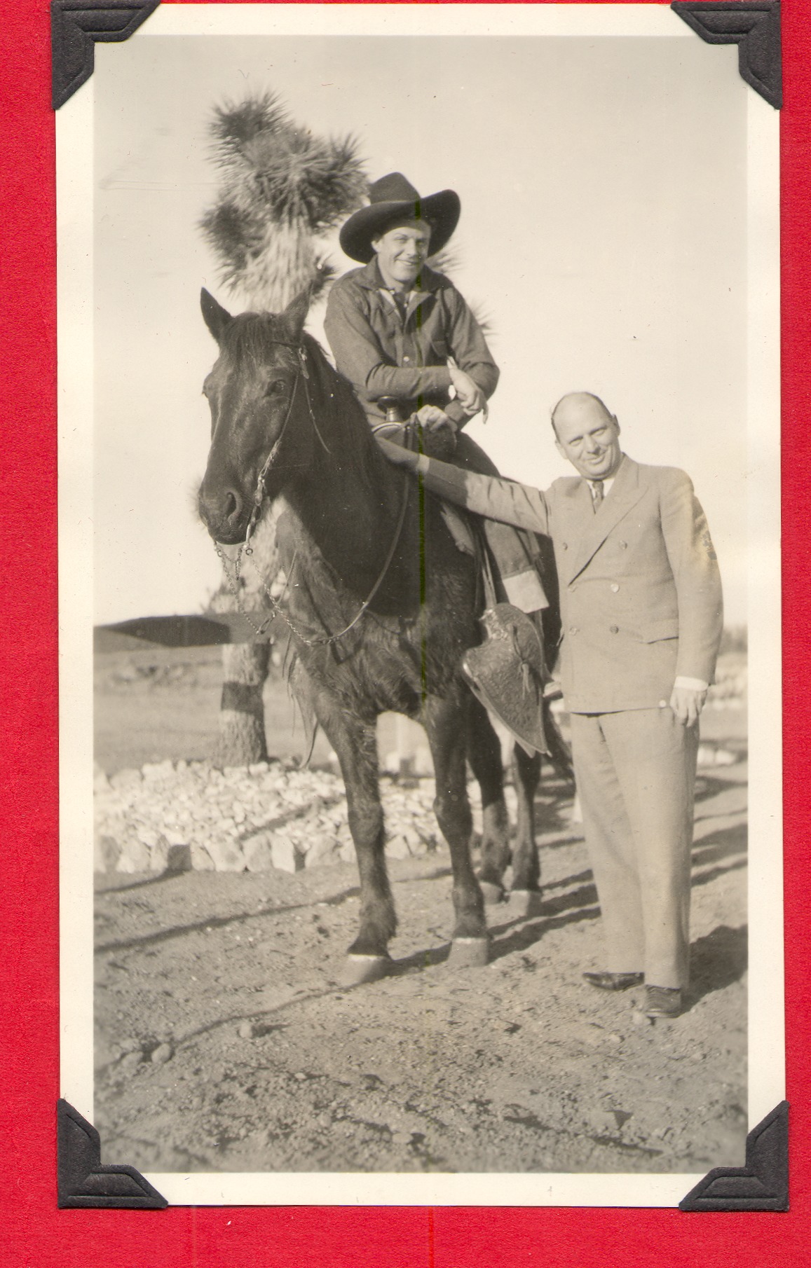 Rex Bell on horseback. Other man is Marion Lewyn's husband: photographic print