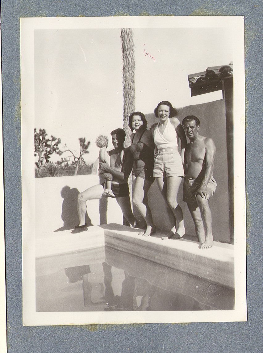 Group standing by the ranch swimming pool. At left, Rex holding Bell Jr. , and Clara: photographic print