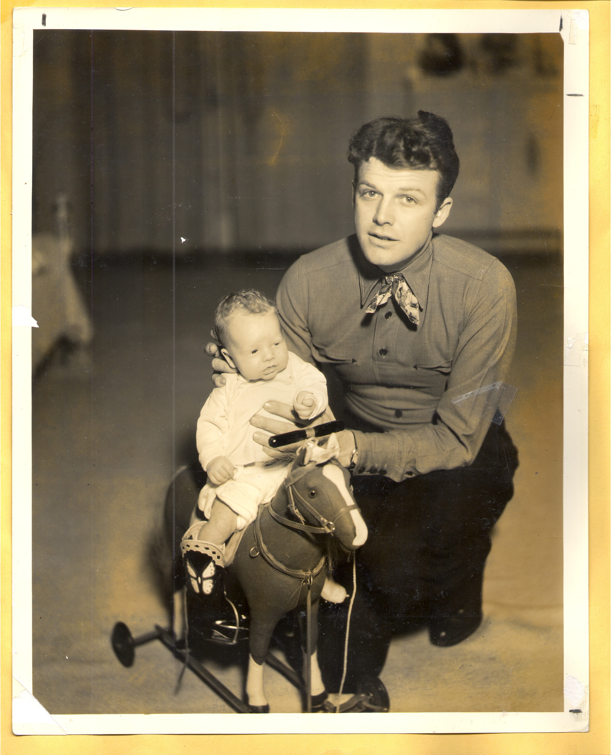 Rex Bell with Rex Jr. on hobby horse: photographic print