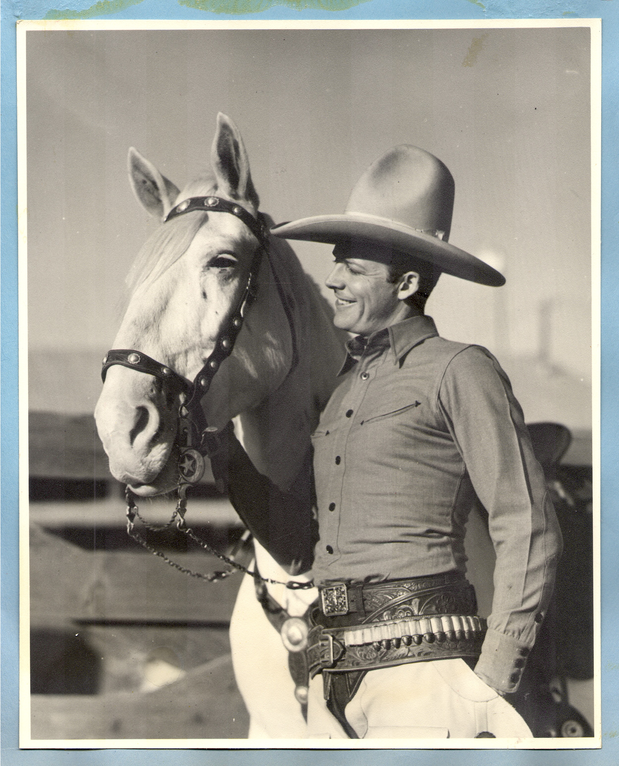 Rex Bell standing next to his horse: photographic print