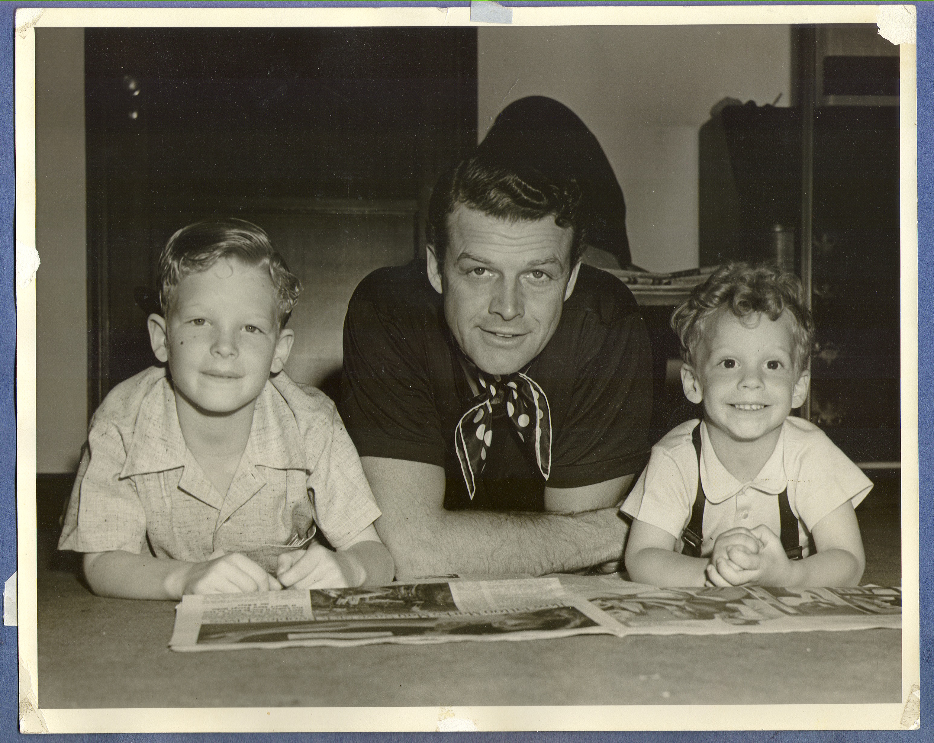 Rex Bell Jr., Rex Bell, and George Bell reading: photographic print