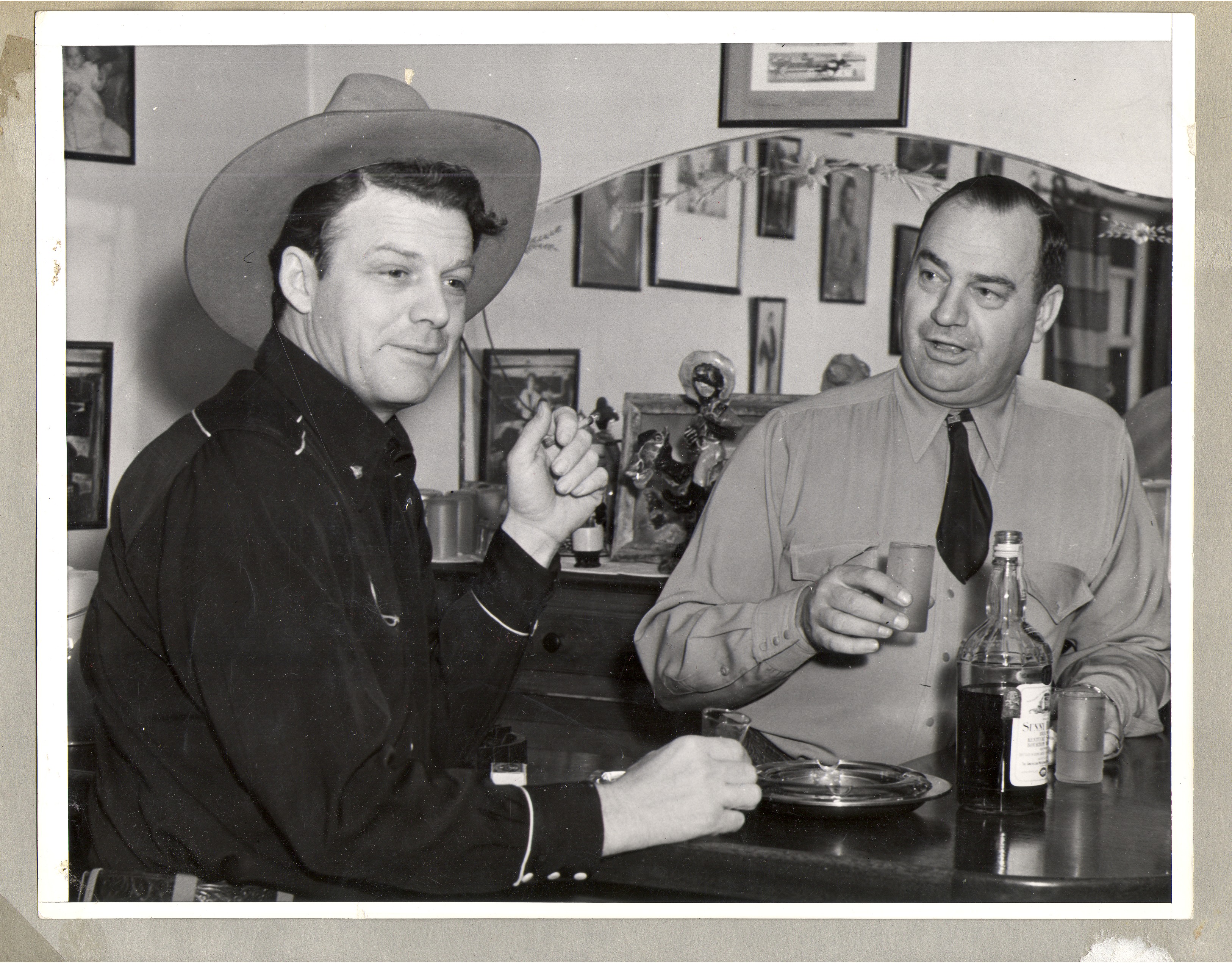 Rex Bell, left, seated at the bar with Bill Frolicki: photographic print