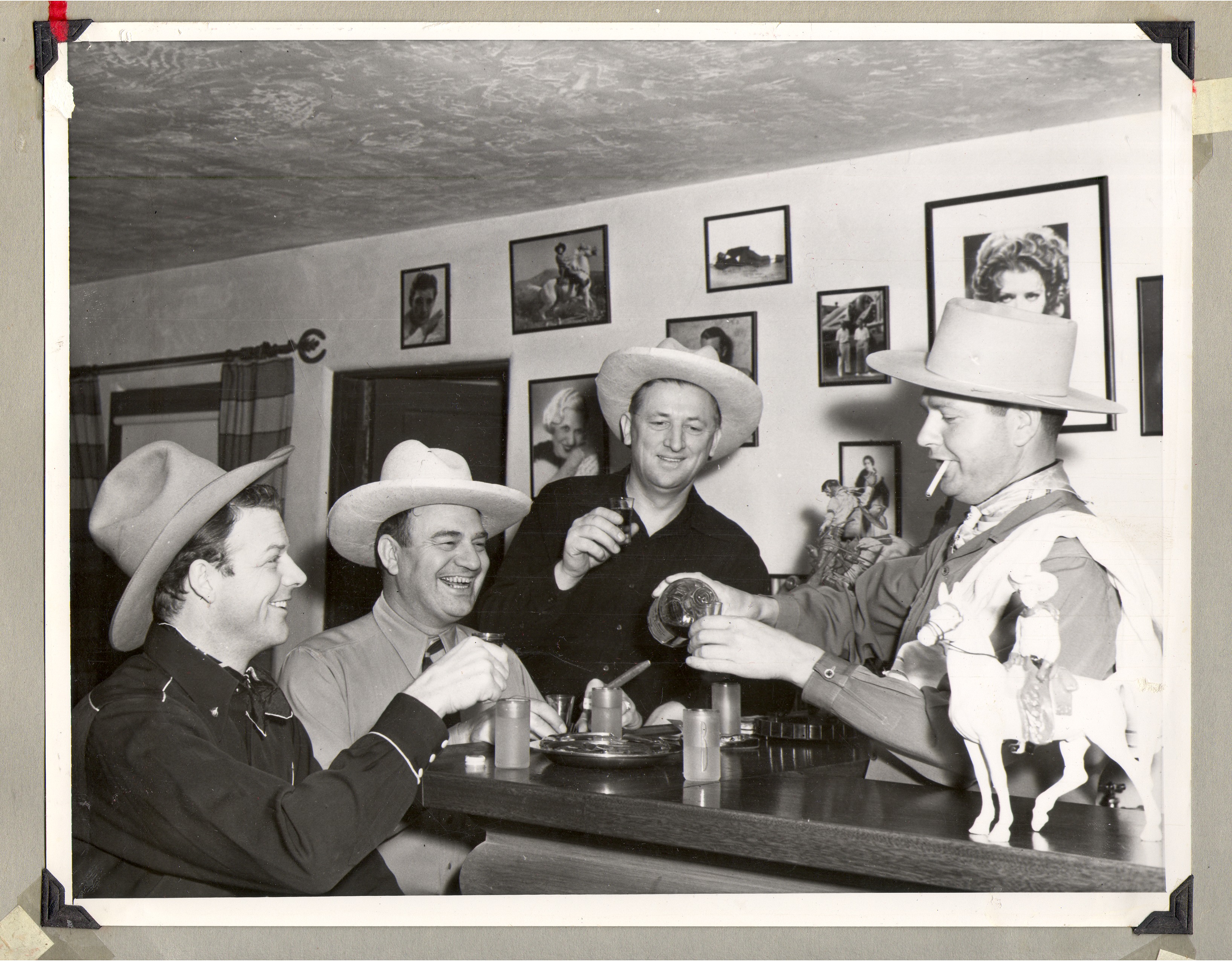 Rex Bell (left) with three other men at a bar: photographic print