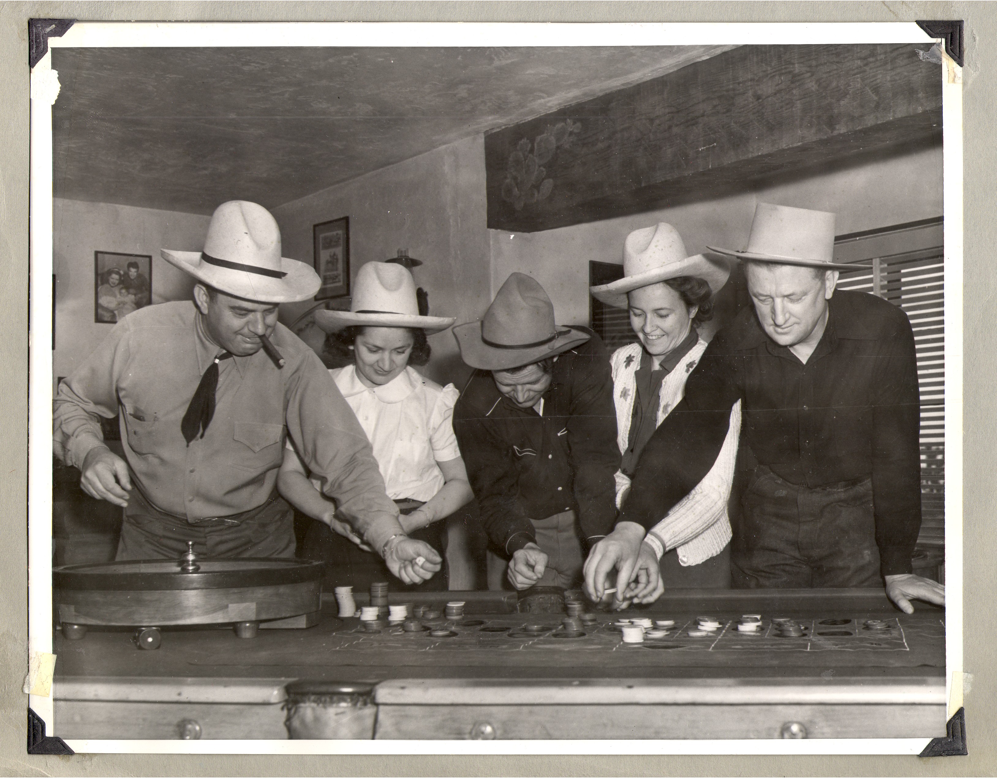 Rex Bell (center with head down) and two couples in the game room at the ranch: photographic print