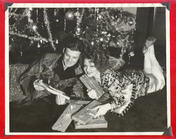 Clara Bow Bell and husband Rex opening Christmas gifts under the Christmas tree at Walking Box Ranch, Nevada: photographic print