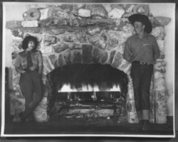 Clara Bow and Rex Bell in front of the fireplace at Walking Box Ranch: photographic print
