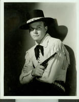 Studio photograph from Universal Studio Pictures Corp. film Battling with Buffalo Bill.  Rex Bell (George Francis Beldam) in costume. Copyright notice on back of image: Freulich, Universal Pictures Corp.  Also labeled:"Rex Bell who is featured in the Universal serial 'Battling with Buffalo Bill.'"