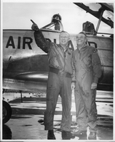 Photograph of Rex Bell (George Francis Beldam) and unidentified man near an airplane at an unknown location. Stamped on back: Gene Christensen Reno-NV