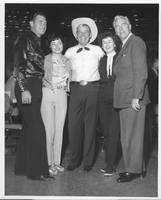 Rex Bell (George Francis Beldam) at center with four unidentified people at an unknown location. Stamped on back: Las Vegas News Bureau, Las Vegas, Nev. - P.O. Box 28,  Photographers Don English, Joe Buck, Jerry Abbott, Milt Palmer