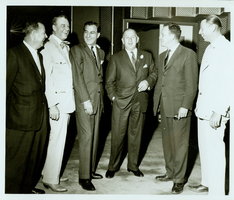 Rex Bell (George Francis Beldam) (second from left) with an unidentified group in an unknown location. Stamped on back: Las Vegas News Bureau, Las Vegas, Nev. - P.O. Box 28,  Photographers Don English, Joe Buck, Jerry Abbott, Milt Palmer